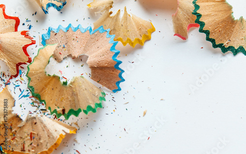 Creative frame made of color pencil shavings a on a white paper.