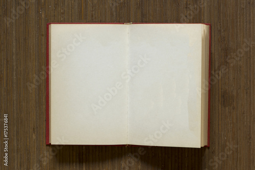 A white open book on a brown mat