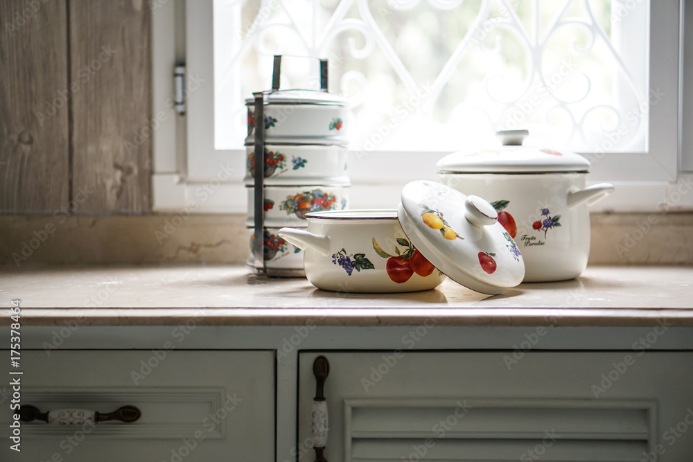 Vintage cooking pot and tiffin carrier set on the kitchen table