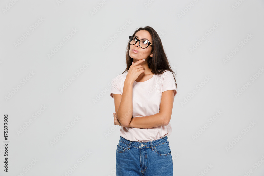 Portrait of a pensive young asian woman in eyeglasses looking Portrait of a pensive young asian woman in eyeglasses looking