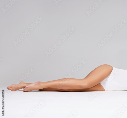 Close-up of beautiful, fit and sporty legs isolated on white. Health, sport, fitness, epilation, cellulite and hair removal, liposuction, healthy life-style concept.