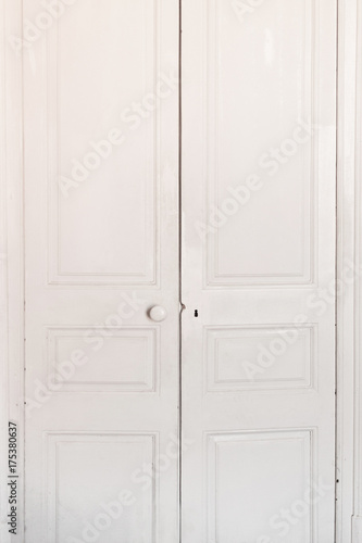 White Old classic door. Antique dirty door in a room, closed.