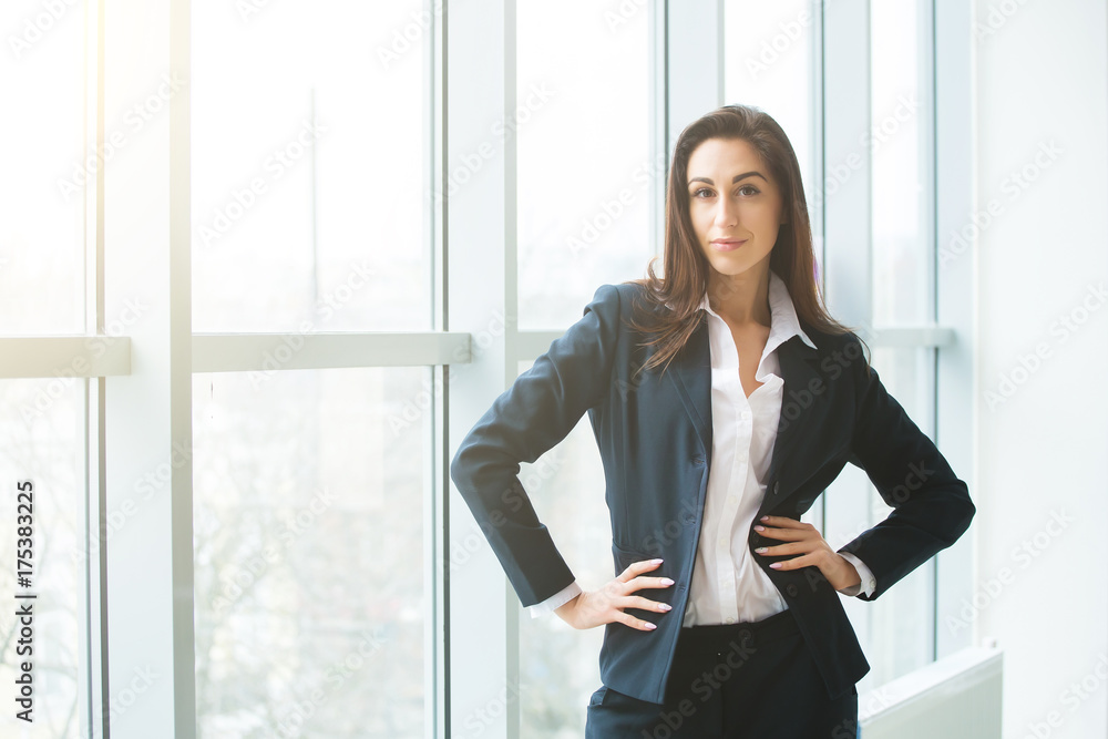 Young businesswoman sitting at workplace and reading paper in office Young businesswoman sitting at workplace and reading paper in office