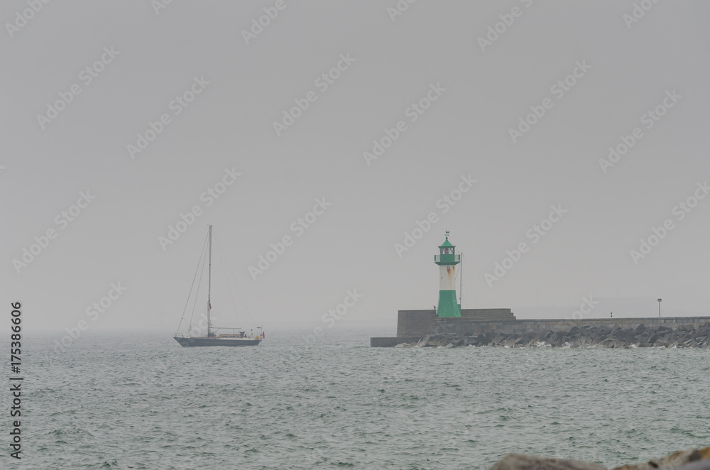 Lighthouse with ship in rainy day, Sassnitz, Germany