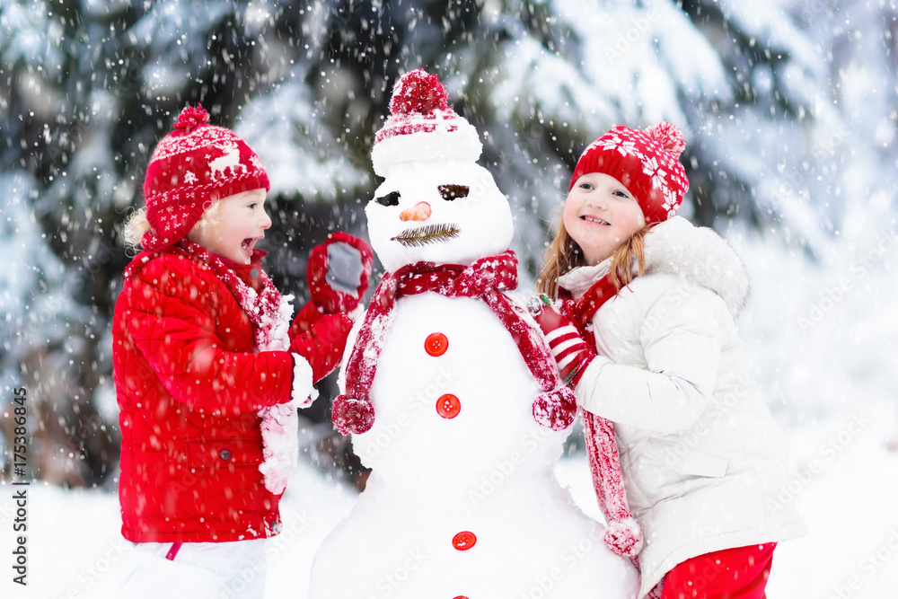 Kids building snowman. Children in snow. Winter fun. Kids building snowman. Children in snow. Winter fun.