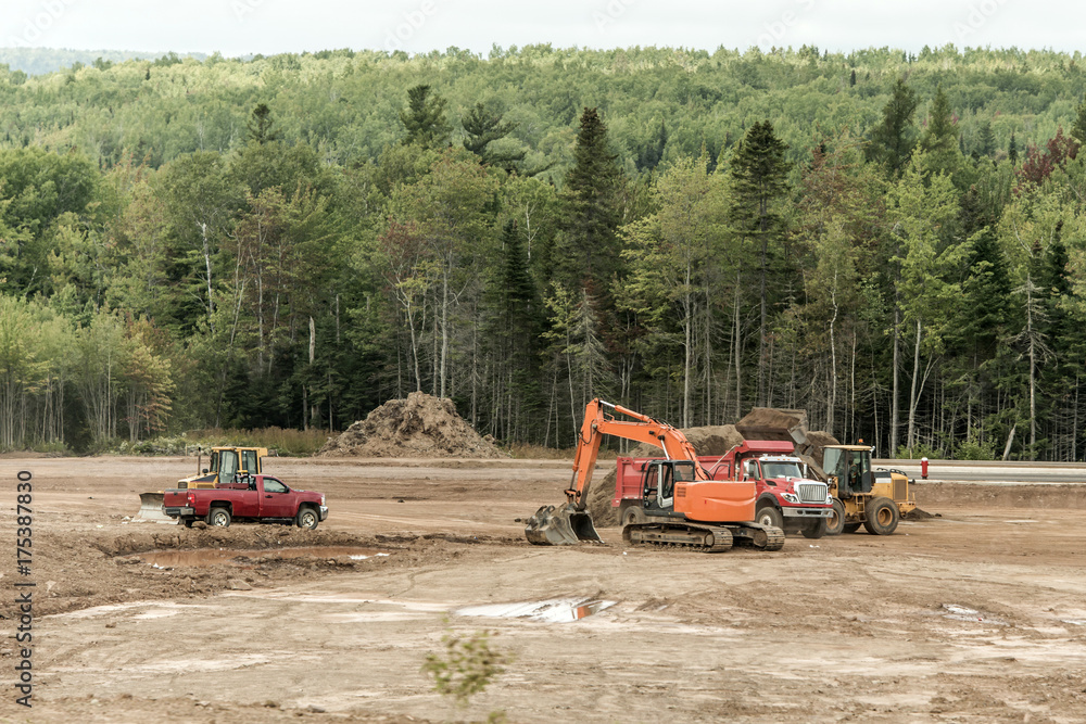 Clearcut forest deforest machines trucks excavator in New Brunswick Canada Clearcut forest deforest machines trucks excavator in New Brunswick Canada