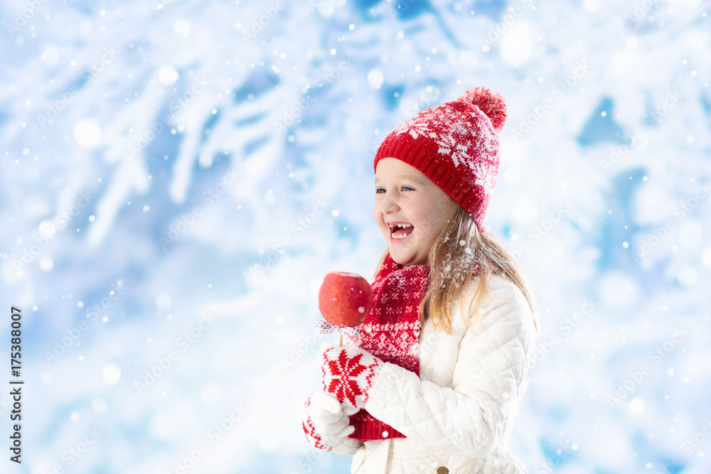 Child with candy apple on winter fair Child with candy apple on winter fair