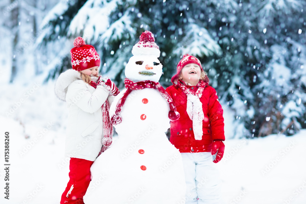 Kids building snowman. Children in snow. Winter fun. Kids building snowman. Children in snow. Winter fun.