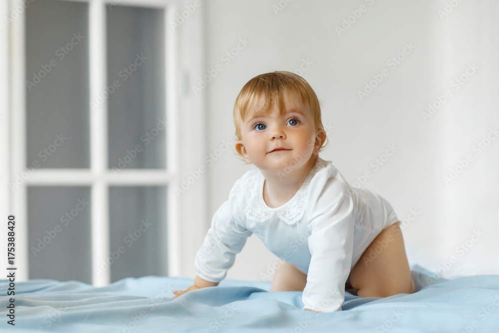 Smiling baby girl sit on the bed Smiling baby girl sit on the bed