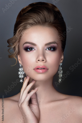Beautiful woman portrait with jewelry in hair and tender make up. Luxury bride.