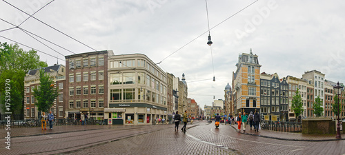 City of Amsterdam: tourists on the bridge in the old city