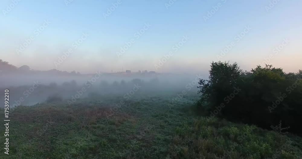 Air view of the village with fog, inium, church and river Air view of the village with fog, inium, church and river