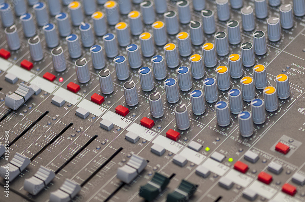 Fototapeta premium Close-up on knobs of an audio console. Digital audio board. Studio workstation. Mixing console.