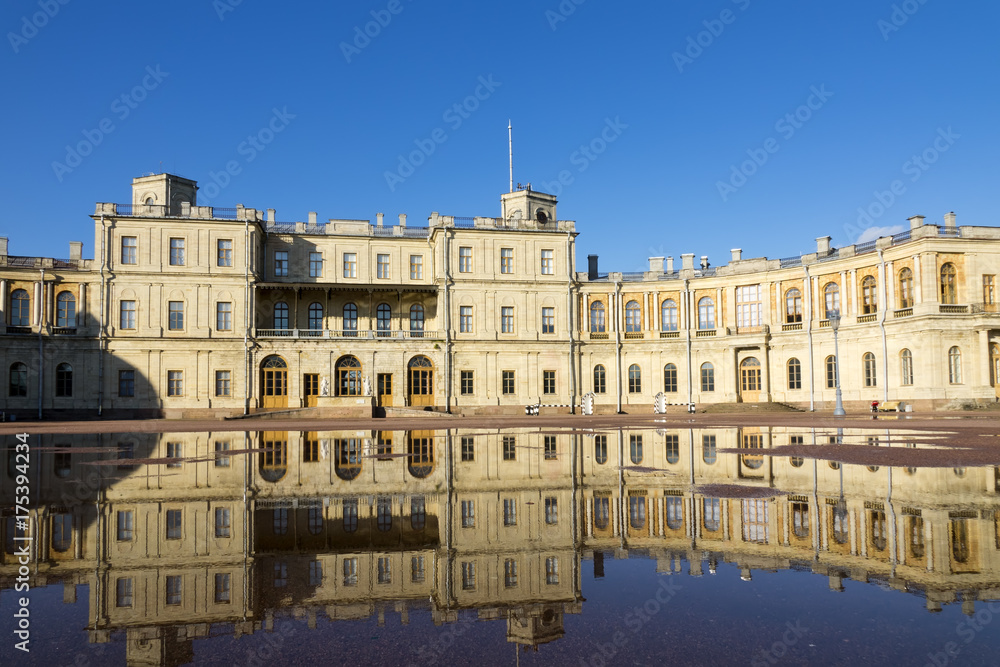 Russia, suburb of St. Petersburg. Great Gatchina Palace (1766 — 1781) and parade-ground. Reflection in pools after a rain.