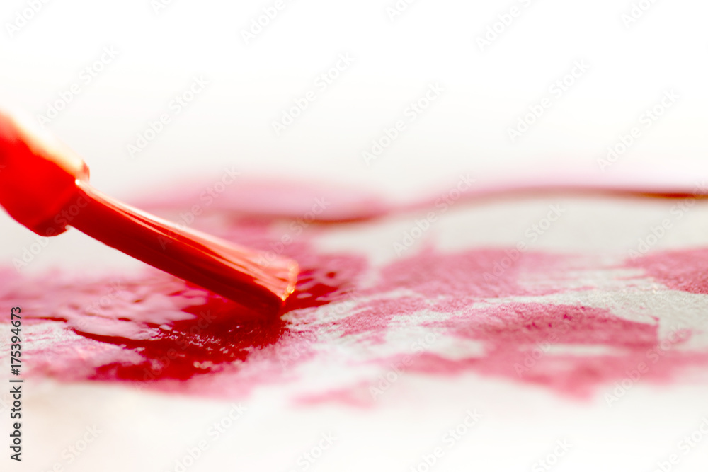 Little brush painting red lines on a white papper Little brush painting red lines on a white papper