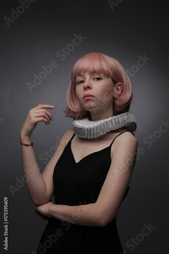 Girl in a medieval collar on a gray background
