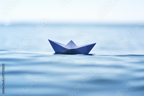 Paper boat on sea wave