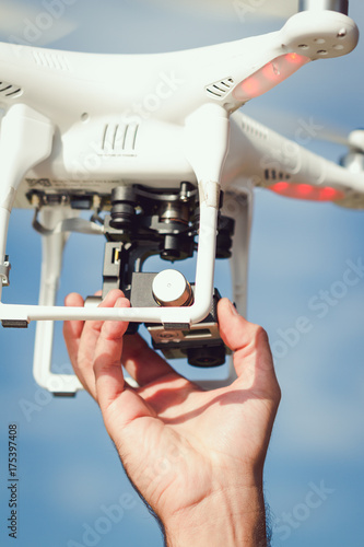 closeup operator hand setting up drone for recording photo
