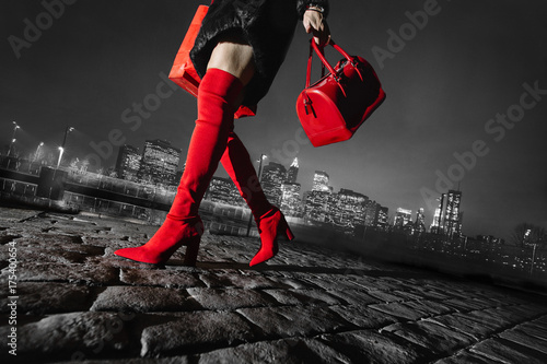 legs beautiful woman shopping in New York, red boots and bag