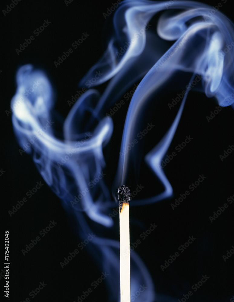 Single smoking match on black background Single smoking match on black background