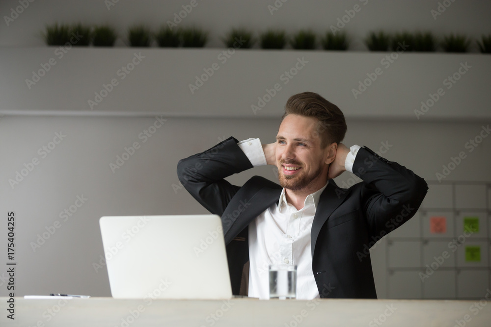 Smiling dreamy businessman rests hands behind his head. Employee stretching his back, raking a break from workflow. CEO dreams about success, chilling after positive meeting, finished project concept. Smiling dreamy businessman rests hands behind his head. Employee stretching his back, raking a break from workflow. CEO dreams about success, chilling after positive meeting, finished project concept.