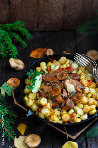 Saffron milk cap mushrooms with fried potatoes, rustic style photo