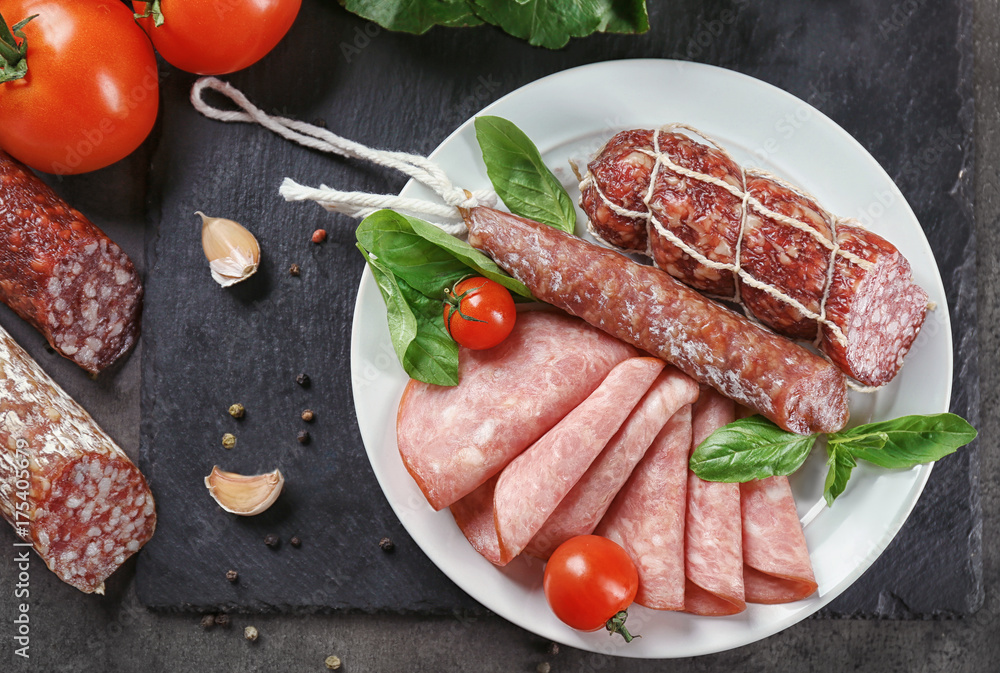 Delicious sliced sausages on plate Delicious sliced sausages on plate