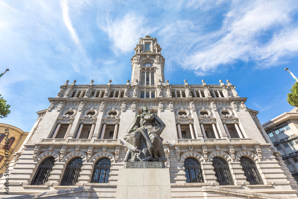 Bottom view of majestic facade of Porto City Hall or Camara Municipal do Porto in Avenida dos Aliados, Liberty square, Oporto in Portugal. Sunny day in the blue sky.