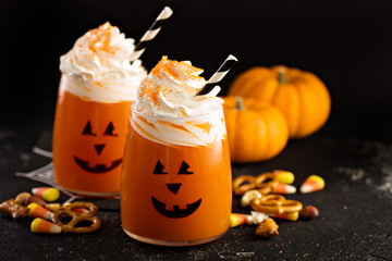 Halloween cold cocktail or drink with jack o'lantern face