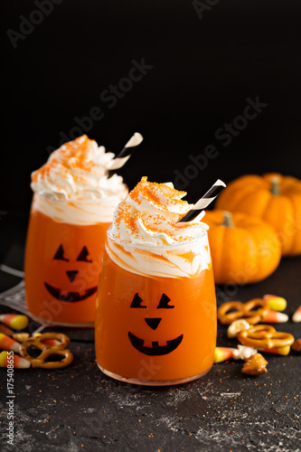 Halloween cold cocktail or drink with jack o'lantern face