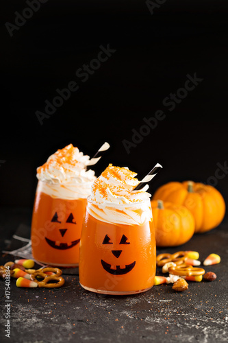 Halloween cold cocktail or drink with jack o'lantern face