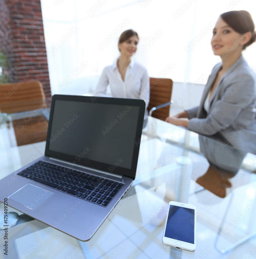 laptop and a smartphone on the desktop of a businessman laptop and a smartphone on the desktop of a businessman