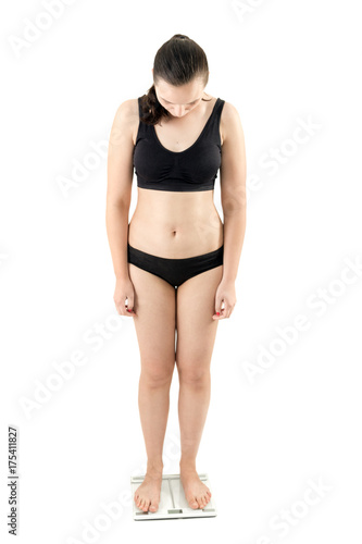 thick overweight woman on scales isolated over white background standing