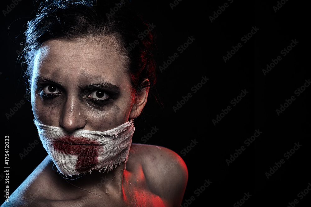 woman with wounded face and smeared cosmetics looking at camera