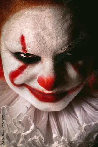 angry evil clown face looking at camera close up