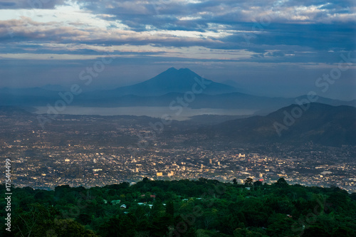 The city of San Salvador, El Salvador at sunset with the view of lake Ilopango and San Vicente Volcano, taken from San Salvador volcano photo