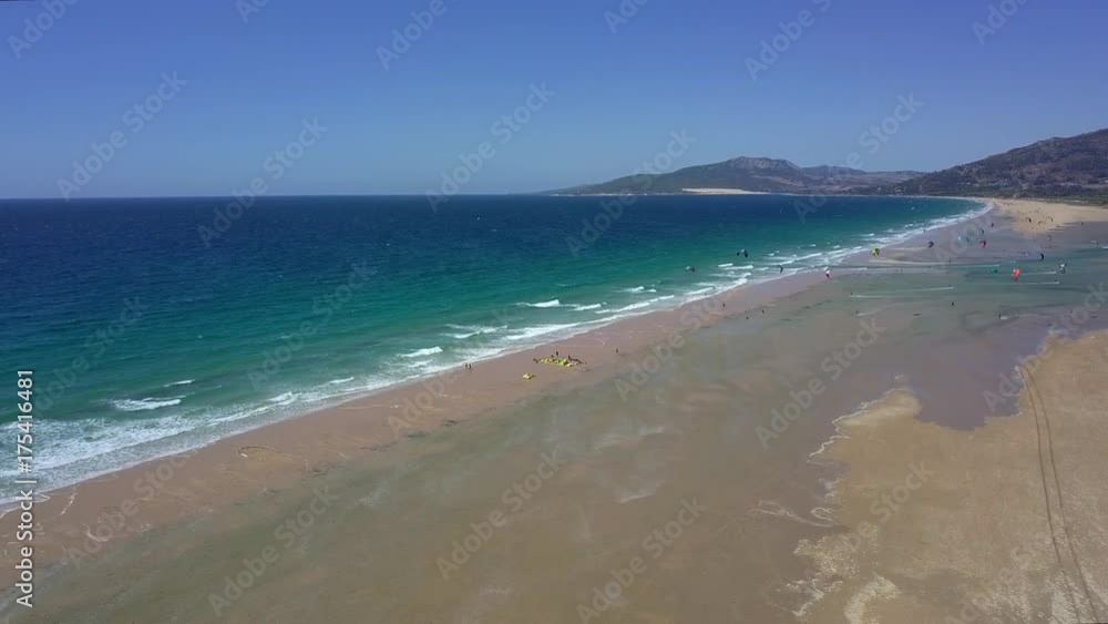 Aerial shot of wonderful view of ocean turquoise water washing sands of beach in tropics making white foam in bright light. Aerial shot of wonderful view of ocean turquoise water washing sands of beach in tropics making white foam in bright light.