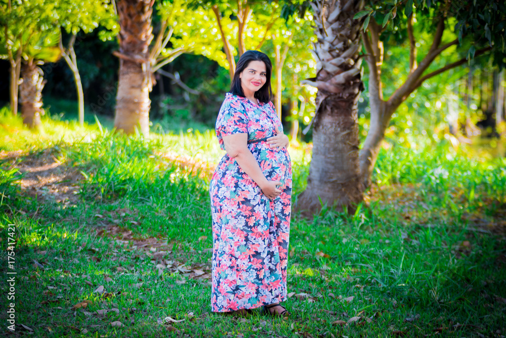 Pregnant woman in outdoor - Holding belly Pregnant woman in outdoor - Holding belly