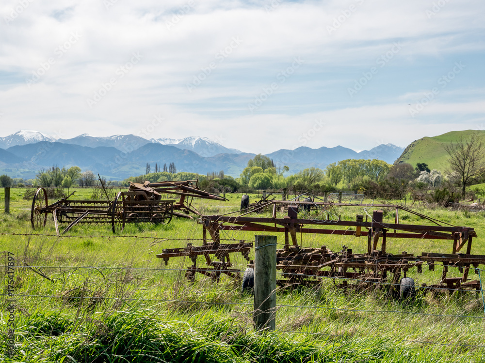 Farm machinery  in New Zealand with snow clad mountains