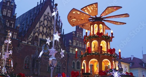 European Christmas Market Scene. 4K. Traditional pyramid birth of Christ and Decorated with lights Wroclaw (Breslau) City Hall, Advent Christmas Fair. Winter Holiday Season. Travel Europe Concept.