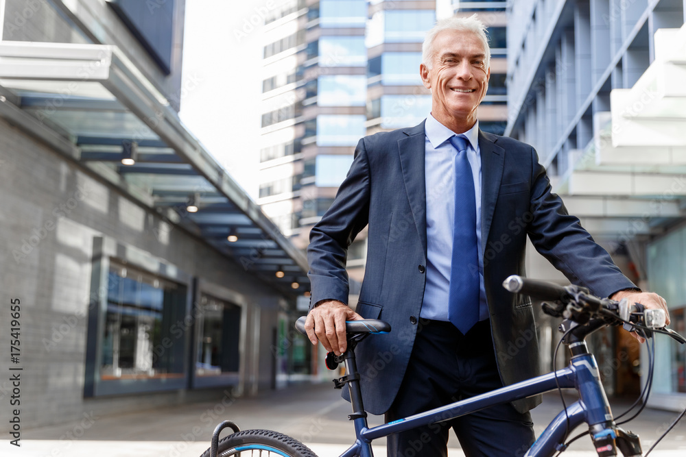 Successful businessman riding bicycle Successful businessman riding bicycle