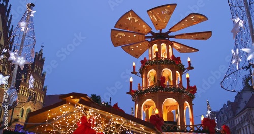 European Christmas Market Scene. 4K. Traditional pyramid birth of Christ and Decorated with lights Wroclaw (Breslau) City Hall, Advent Christmas Fair. Winter Holiday Season. Travel Europe Concept.