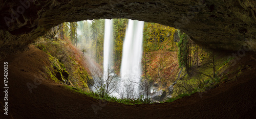 Fototapeta Naklejka Na Ścianę i Meble -  View of a waterfall from behind through an eye shaped cave