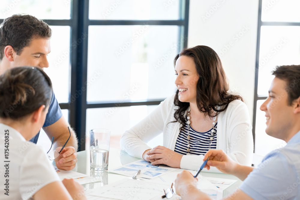Image of business partners discussing documents and ideas Image of business partners discussing documents and ideas