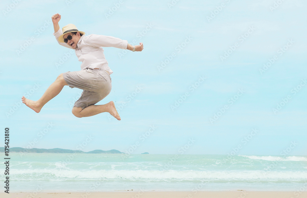 Man jump happy during vacation at sea beach of Thailand Man jump happy during vacation at sea beach of Thailand