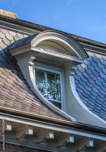 Fotografi A dormer window with a doomed casement is set in the side of a historic building