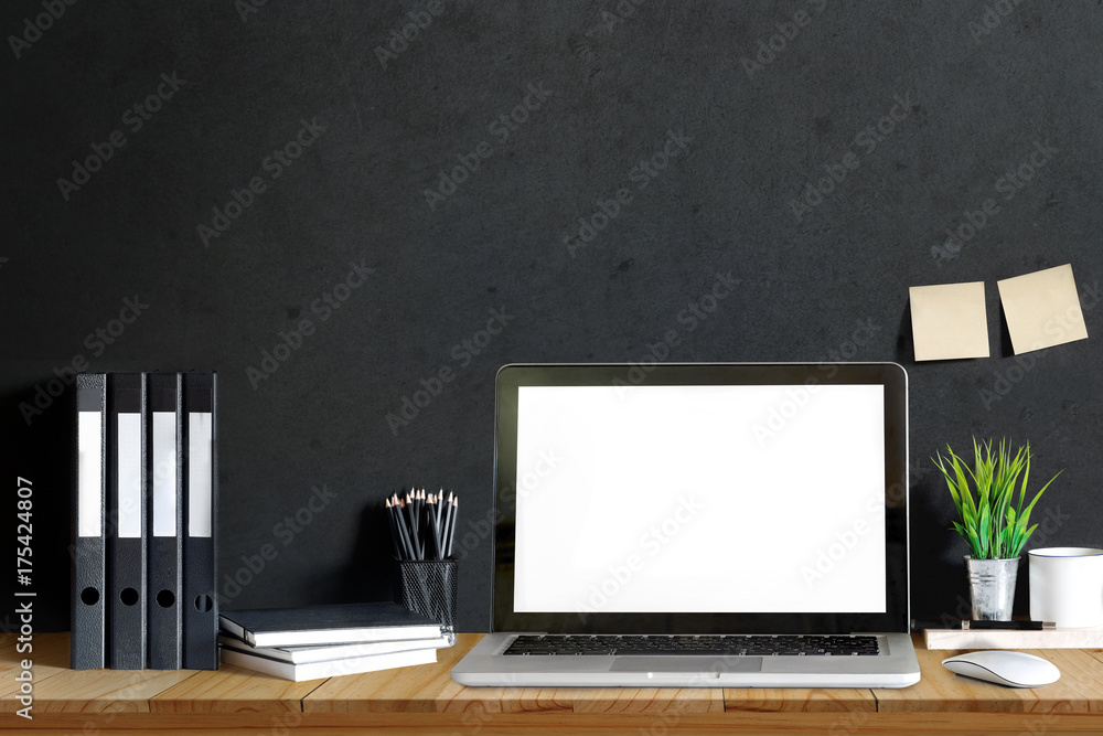 Workplace with modern laptop computer on table, business desk space with files, books, pencils, houseplant and supplies. Workplace with modern laptop computer on table, business desk space with files, books, pencils, houseplant and supplies.