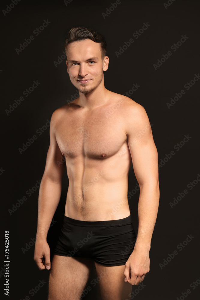 Young man in underwear on black background Young man in underwear on black background