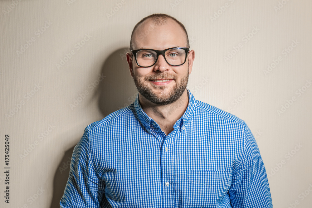 Obraz premium Young man with glasses on light background