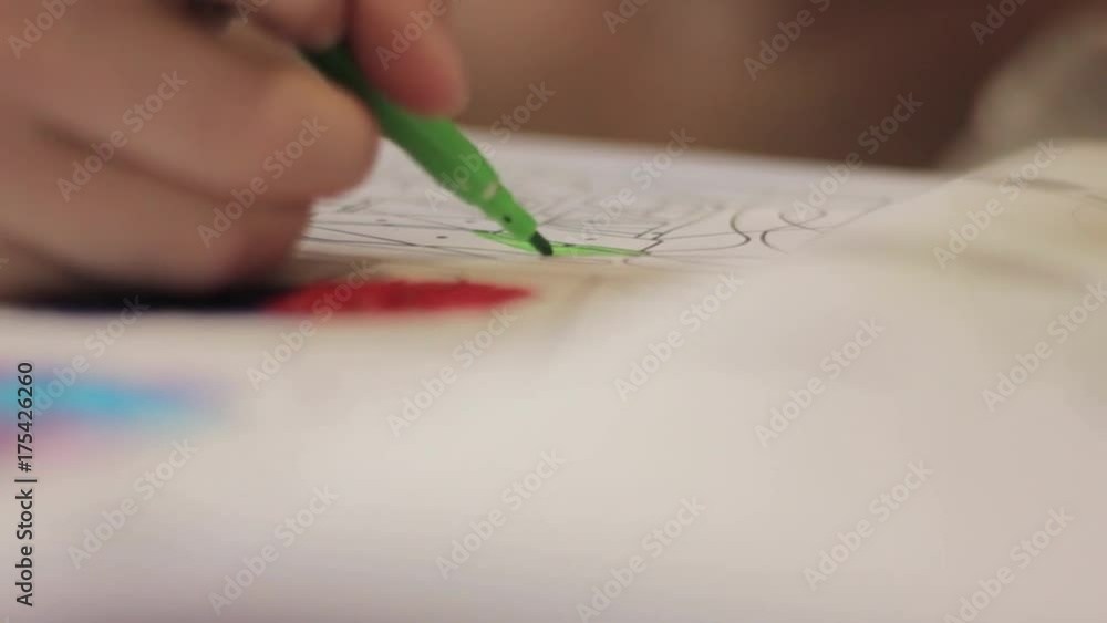 Close-up kid hands with pencil. child draws with colored pencil on paper. Close-up kid hands with pencil. child draws with colored pencil on paper.